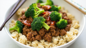 A healthy keto ground beef and broccoli stir-fry served over cauliflower rice with a light soy-based sauce.