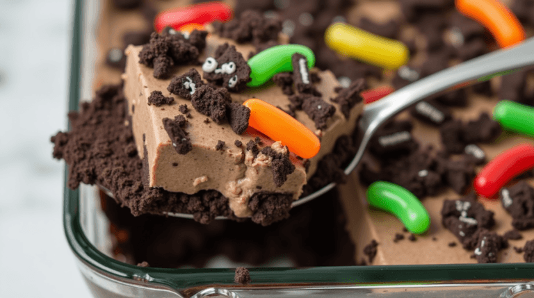 Dirt Cake Recipe with gummy worms in a glass dish.
