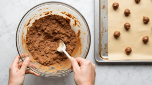 No-bake Butterfinger Balls mixture being mixed in a bowl, ready to be rolled and chilled.